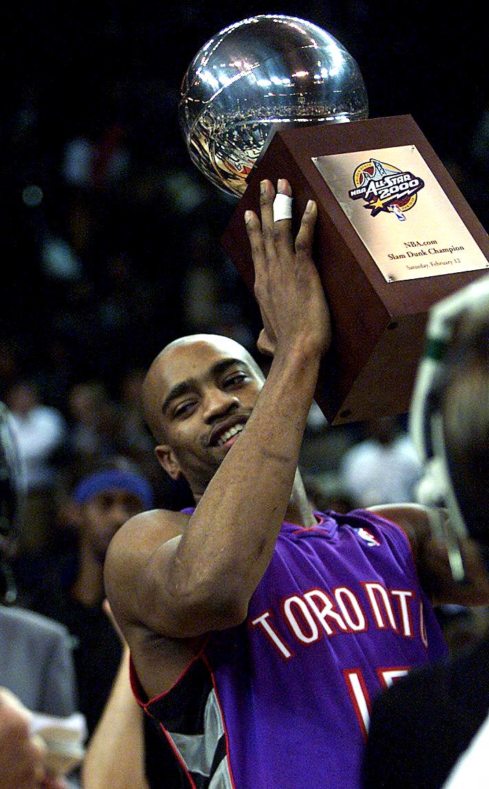 Vince Carter holds the trophy after winning the NBA All-Star Slam Dunk contest in 2000.