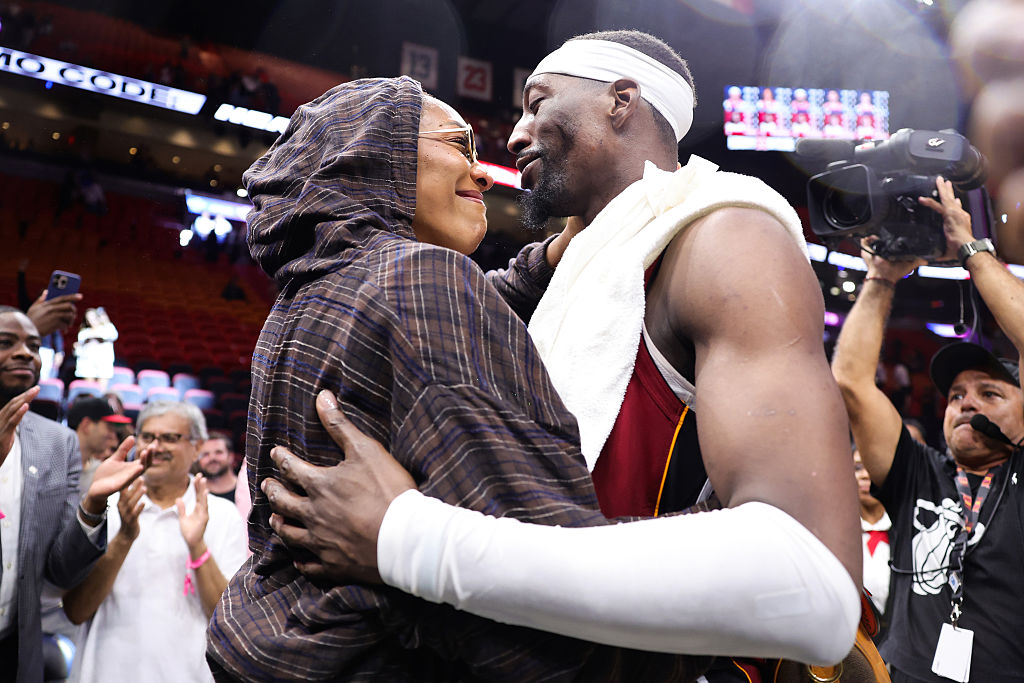 WNBA player A'ja Wilson and NBA player Bam Adebayo embrace after a win. 