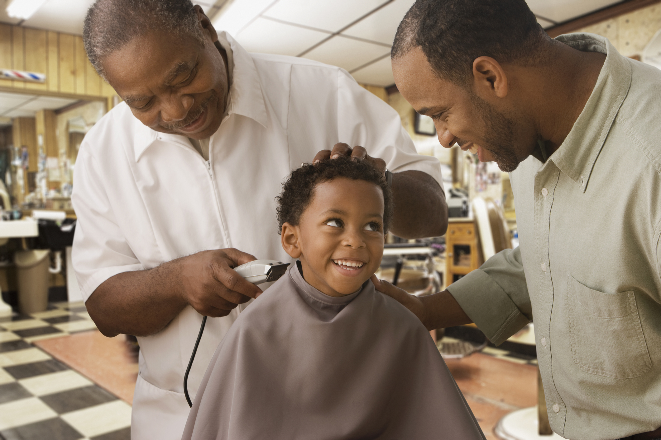 African father and son at barbershop