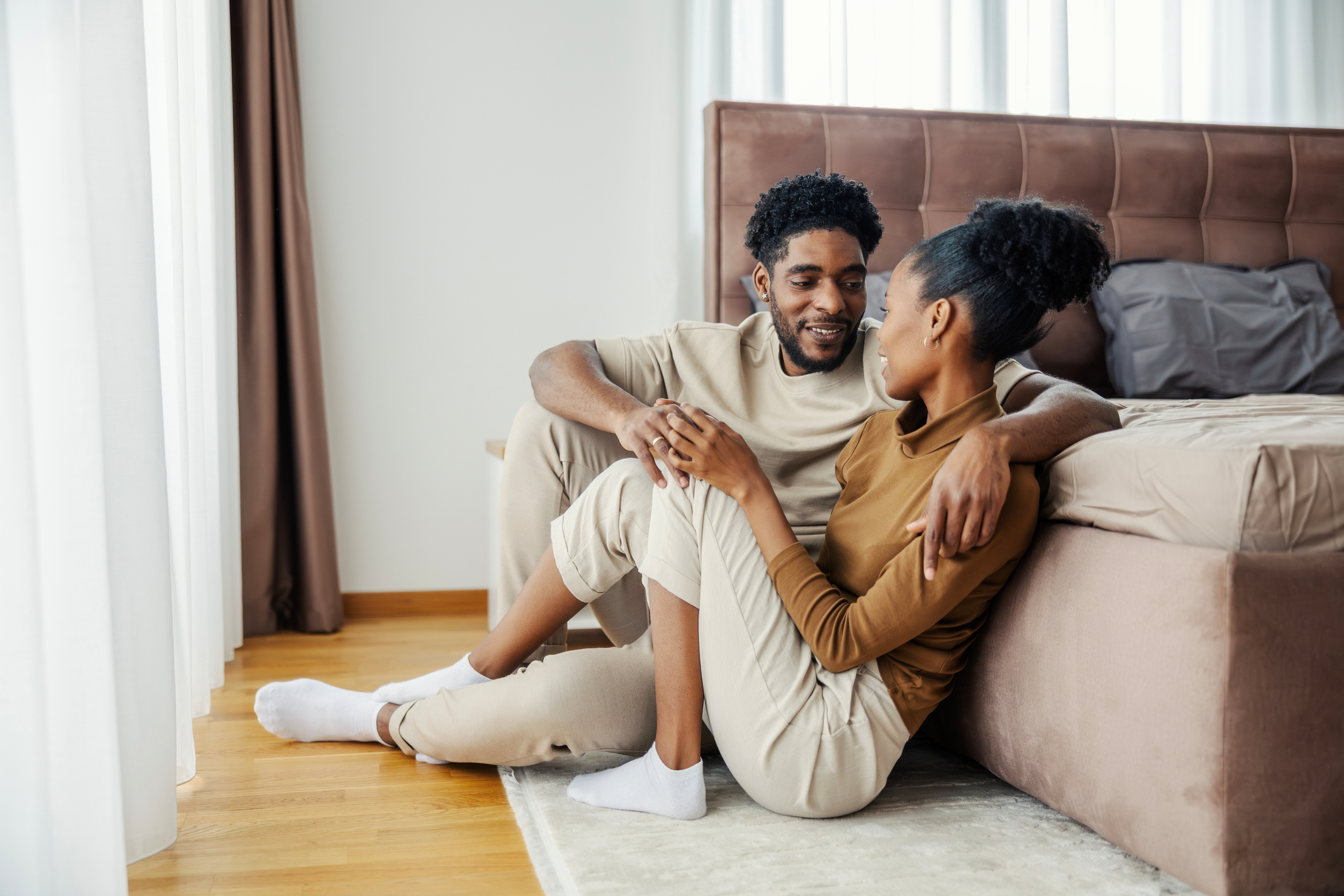 Black couple relaxing at home talking and connecting